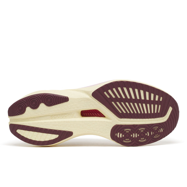 Close-up of a shoe sole with maroon and beige design on a white background