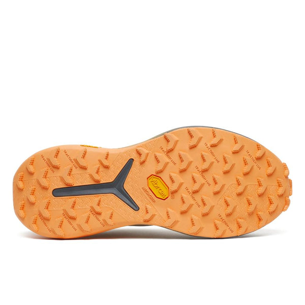White running shoe with orange and gray sole on a white background