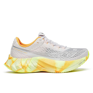 A pair of women's running shoes with white uppers and orange, yellow, and gray accents on a transparent sole.