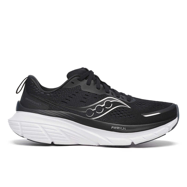 A pair of women's running shoes with black uppers and white bottoms, featuring the Saucony logo.