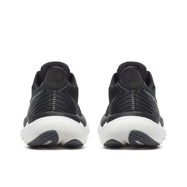 The heel of a women's Saucony black athletic shoes with white soles on a white background.