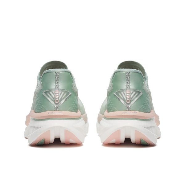 Pair of green running shoes with pink soles on a white background
