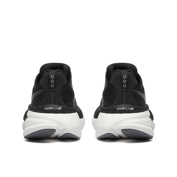 The heel of this black and white running shoe has 3 dots on the back.