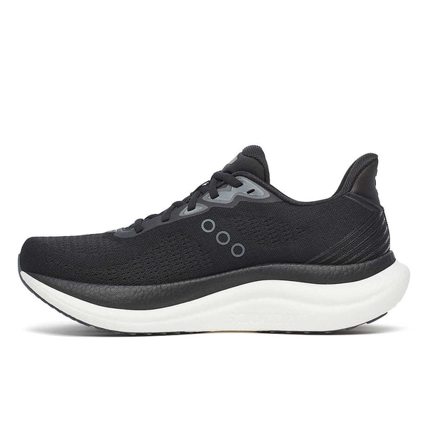 Medial side of ablack running shoe with white sole on a white background.