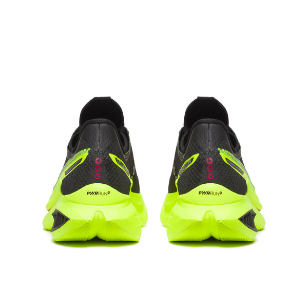Black and neon green running shoes on a white background