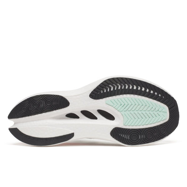 Close-up of a shoe sole with white, black, and green color pattern on a white background
