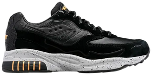 Black and gray sneaker with gold accents on a white background