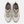 A New Balance athletic sneaker in beige, white, and brown, shown against a plain white background.