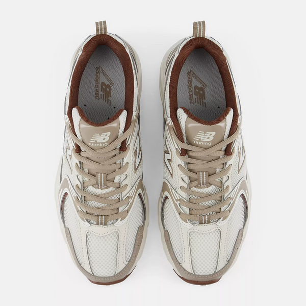 A New Balance athletic sneaker in beige, white, and brown, shown against a plain white background.