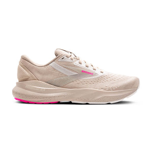 Beige running shoe with pink sole on a white background.
