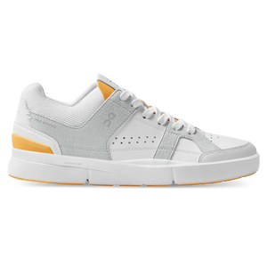 Gray and white sneaker with orange accents on a white background