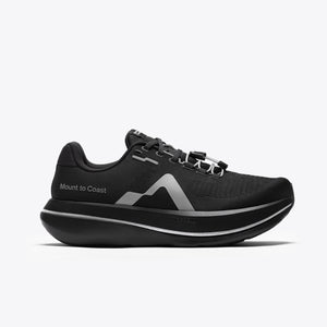 A black Mount to Coast running shoe with a thick black and silver platform sole.