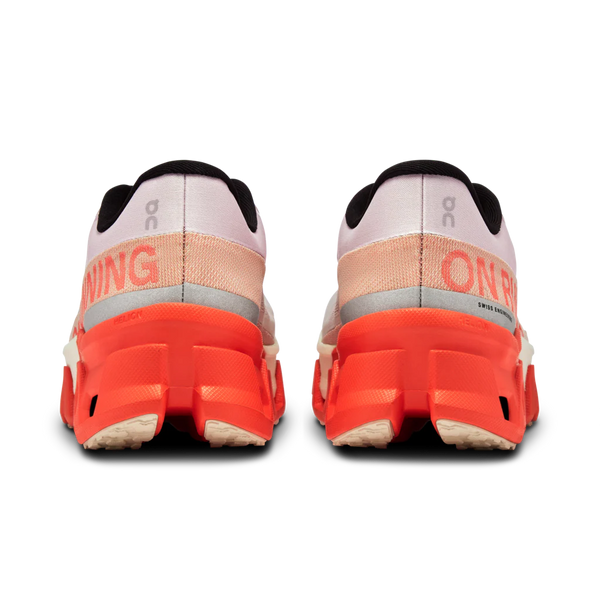 The heel area of an On Running shoe with an orange midsole and a mostly grey upper.