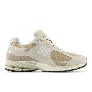 Beige new balance lifestyle sneaker with New Balance logo on a white background.