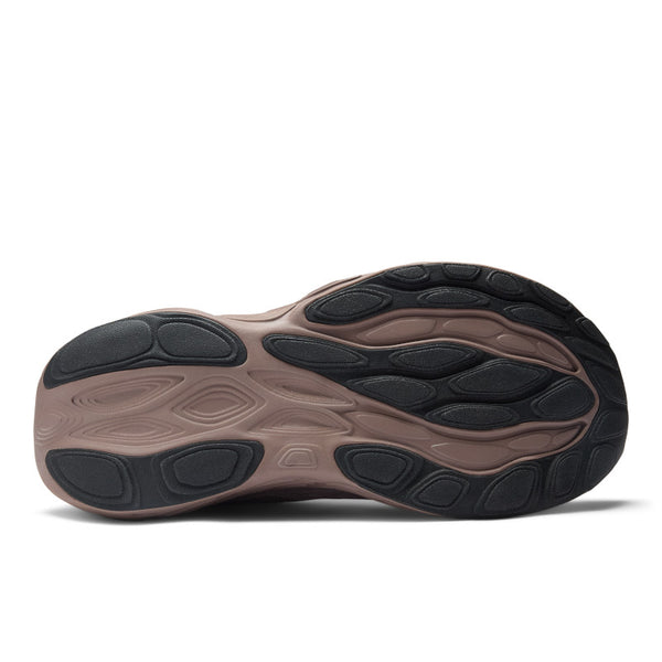 Close-up of a shoe sole with brown and black color scheme on a white background.
