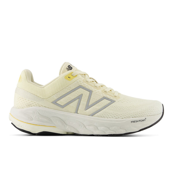 A pair of women's New Balance 860 V14 running shoes in yellow color with grey and white accents.