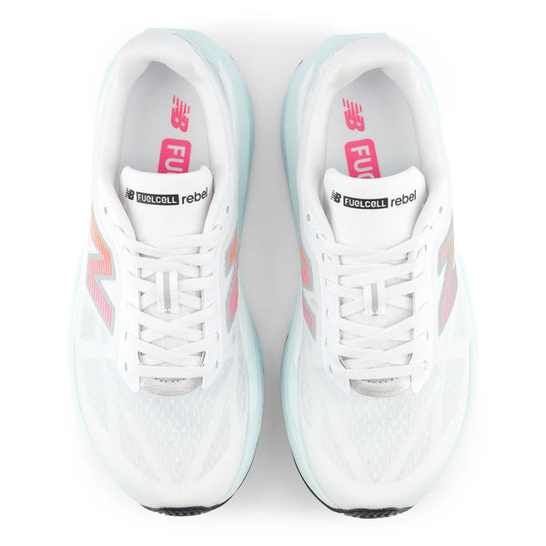 A pair of New Balance Rebel running shoes shown from a top-down view on a white background. The shoes are primarily white with light mint green accents on the midsole and collar, and pink accents on the logo and tongue.