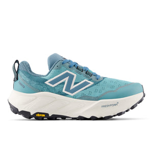 Light blue and treal women's trail running and hiking shoe from new balance.