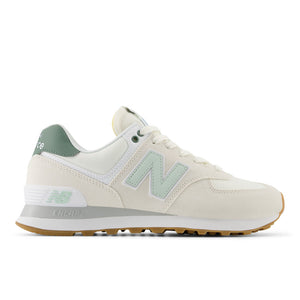 Beige sneaker with green accents on a white background