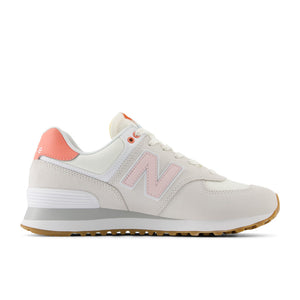 White 574 sneaker with pink accents on and a pink heel tab.