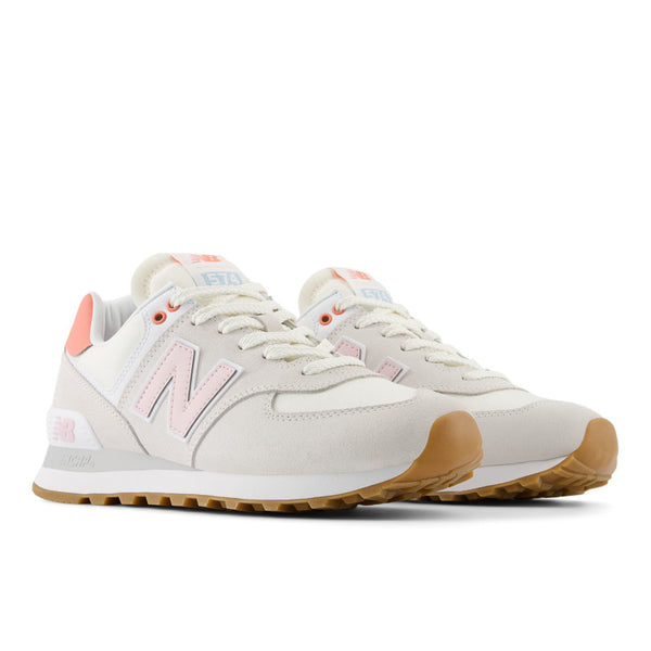 A pair of New Balance 574 shoes from women with light pink laces and upper.