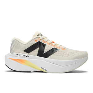 A pair of New Balance women's running trainers with white uppers, black, orange, and yellow accents, and a gray outsole.