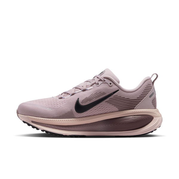The medial side of a pink Vomero 18 running shoe with black swoosh logo on a white background.