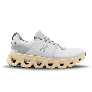 White athletic shoe with beige sole on a white background.