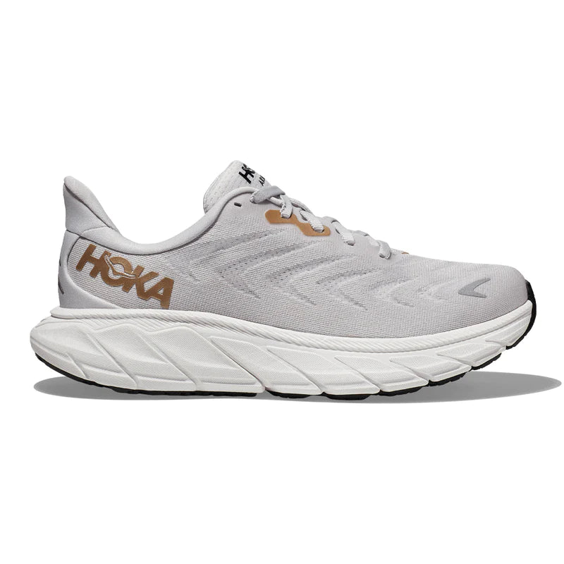 Lateral view of the Women's Arahi 6 by HOKA in the wide D width, color Nimbus Cloud/Rose Gold