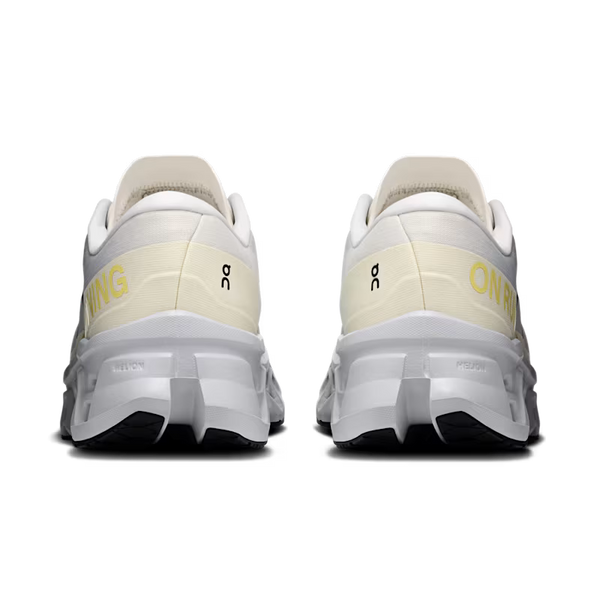 Rear view of a pair of On running shoes in off-white and light gray, featuring yellow 'ON' branding and a black logo on the heel counter, set against a plain white background.