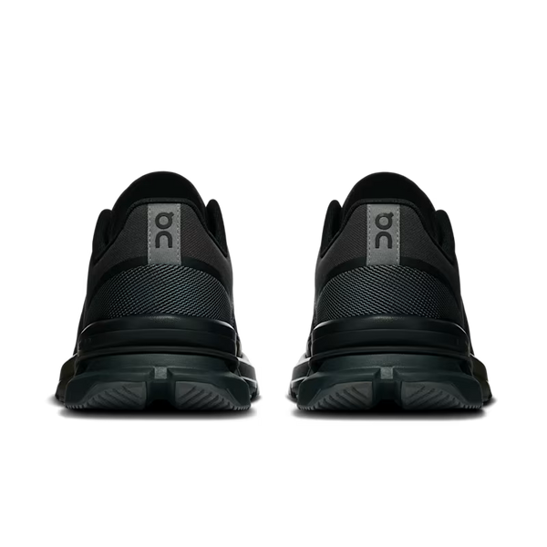 A pair of black training shoes shown from the back, featuring a textured mesh and synthetic upper with a gray 'on' logo on the heel tabs and a thick black midsole.