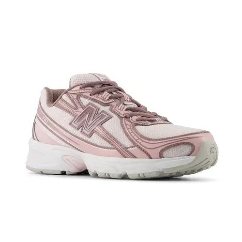 A New Balance athletic sneaker in dusty pink and white, shown against a plain white background.
