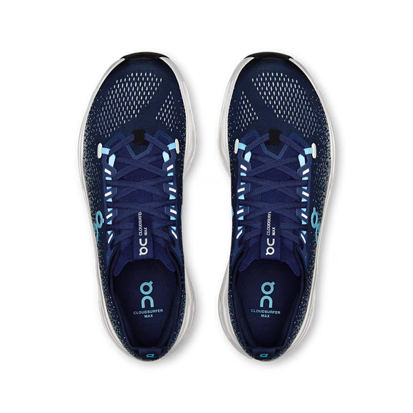 On running shoe in navy blue with a speckled pattern, a light blue On logo, and a white sculpted sole with black cutouts, shown against a plain white background.