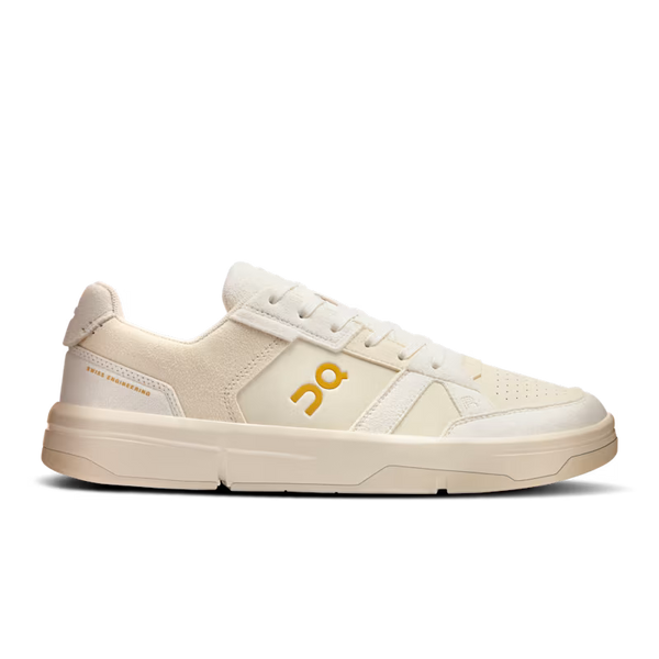 A apair of On lifestyle shoes that have Tennis inspiration with a light tan or peach color.