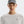 Person wearing a gray cap and white shirt with a brand logo on a white background