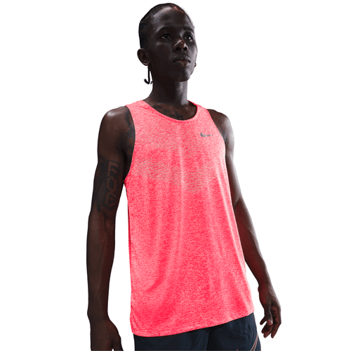Person wearing a bright red Nike tank top on a white background