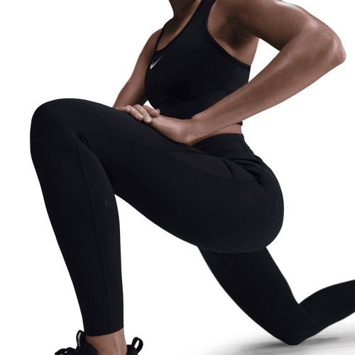 Person wearing black athletic leggings and top on a white background