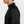 Side view of a person wearing a black long-sleeve athletic shirt on a light gray background