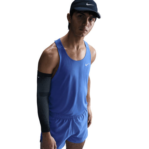Person wearing a blue tank with Nike branding on a white background