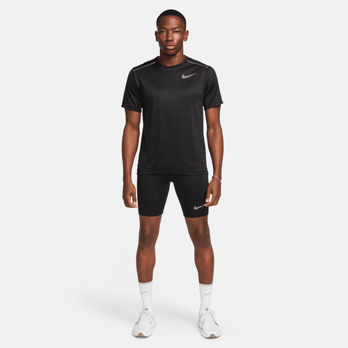 Man wearing a black Nike athletic outfit on a white background