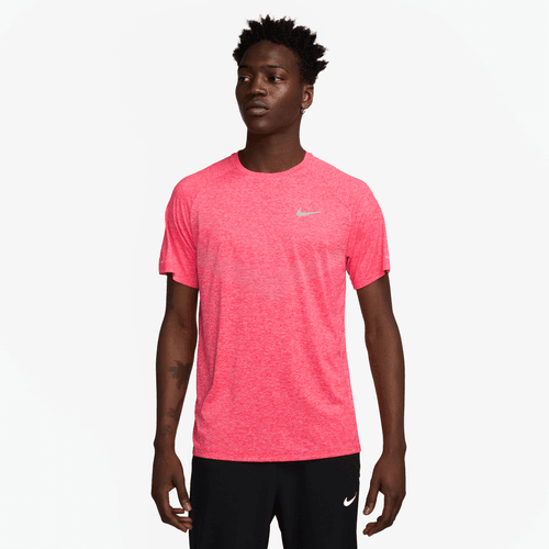 Person wearing a bright red Nike t-shirt on a white background