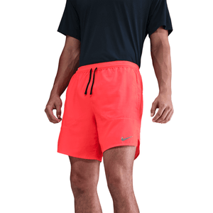 Person wearing bright red Nike shorts on a white background
