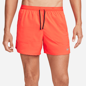 Orange athletic shorts with a Nike logo on a white background