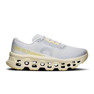 White  and light green Women's On running shoe with yellow accents on a white backgrounds
