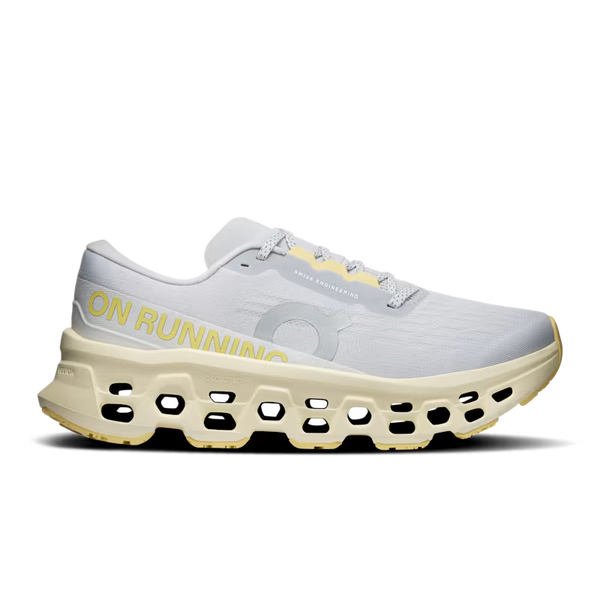 White  and light green Women's On running shoe with yellow accents on a white backgrounds