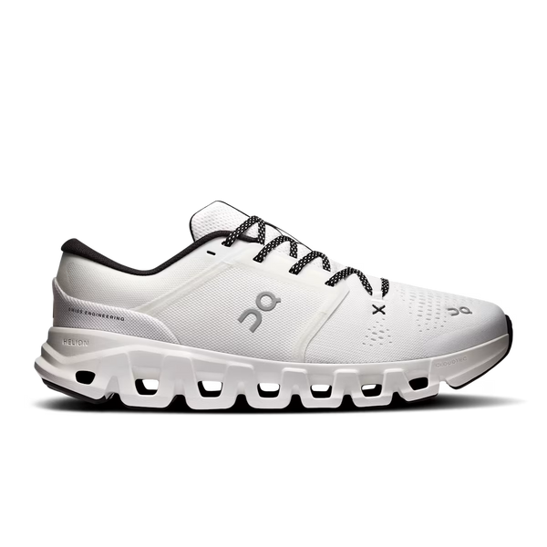 White athletic shoe with black laces on a white background