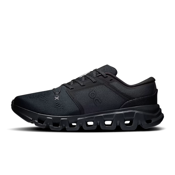 A black athletic sneaker shown from the side profile against a clean white background. The shoe features a textured mesh upper, black laces, and a distinctive chunky, sculpted black sole with cutout details.