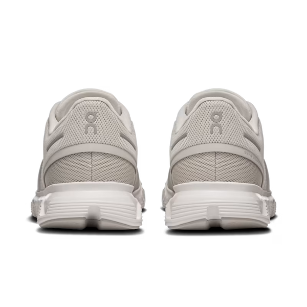 Pair of light gray running shoes with a visible brand logo on a white background