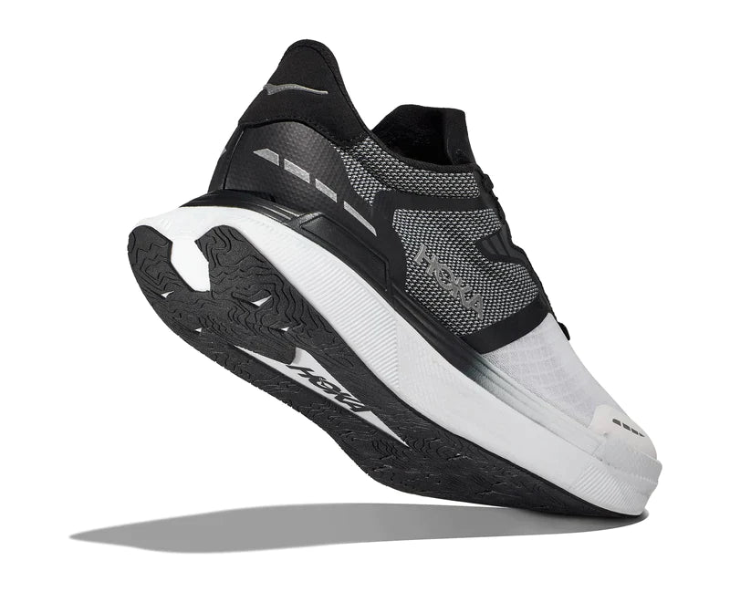 Back angled view of the HOKA Unisex Transport X in Black/White