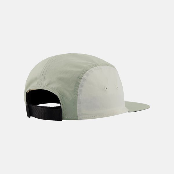 Light green cap with black strap on a white background